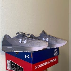 A pair of grey/white Underarmour sneakers!